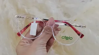 Montura de acetato cristal transparente con varillas doradas y terminales rojo carey, para dama